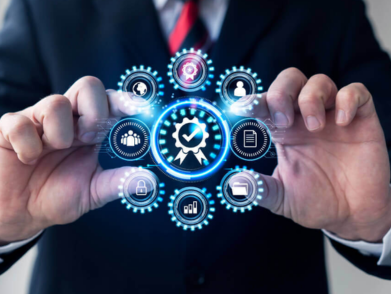 Digital quality assurance concept: businessman holding interface with QA icon and surrounding related icons.